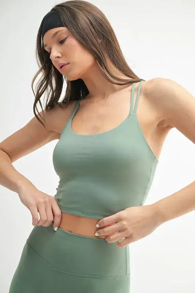 MONO B Venice Cloud Light Crisscross Sports Bra shown in a model wearing a stylish green color.