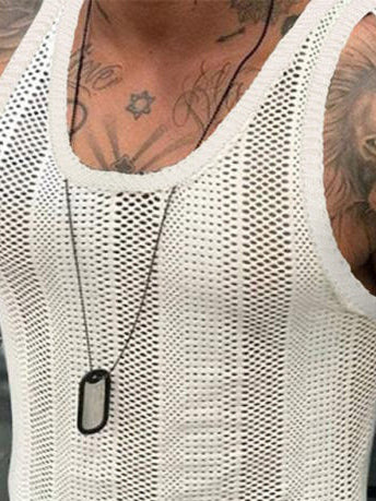 Person wearing a white mesh tank top with tattoos on arms